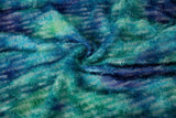 A 3D textured abstract embroidery fabric with a plush feel, in a palette of blue and green