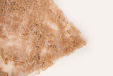 A hand-beaded embroidery fabric, with a pattern of fern-like leaves in a warm, copper-gold color palette.