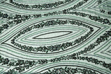 An emerald green Art Deco beaded fabric, with concentric, eye-shaped patterns in black sequins and beads.