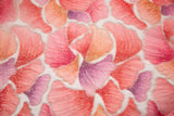 A 3D ribbon and bead embroidery fabric, with feathered petal motifs in a coral and purple gradient.