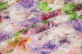 A 3D textured embroidery fabric with a plush feel, in a palette of purple, pink, and green.