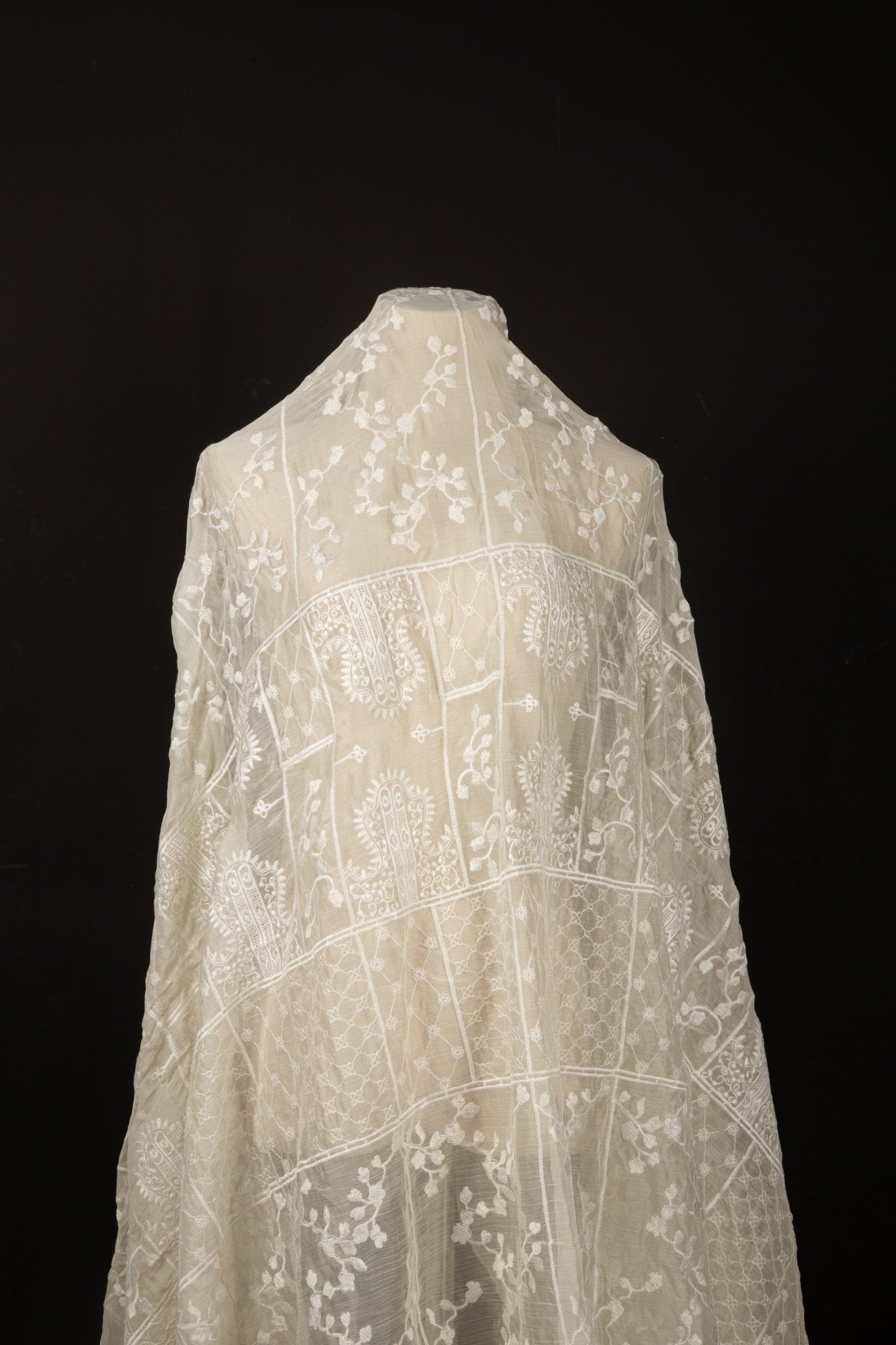 An ivory-white flat embroidery organza fabric, with a horizontal striped pattern of floral friezes and vines.