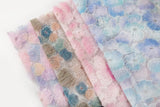 Ice blue, lavender, and white crinkle ribbon embroidered floral fabric.
   Peach, cream, and light pink crinkle ribbon embroidered floral fabric.
    Lavender, pale blue, and soft yellow crinkle ribbon embroidered floral fabric.
   Pink, yellow, and peach crinkle ribbon embroidered floral fabric.
