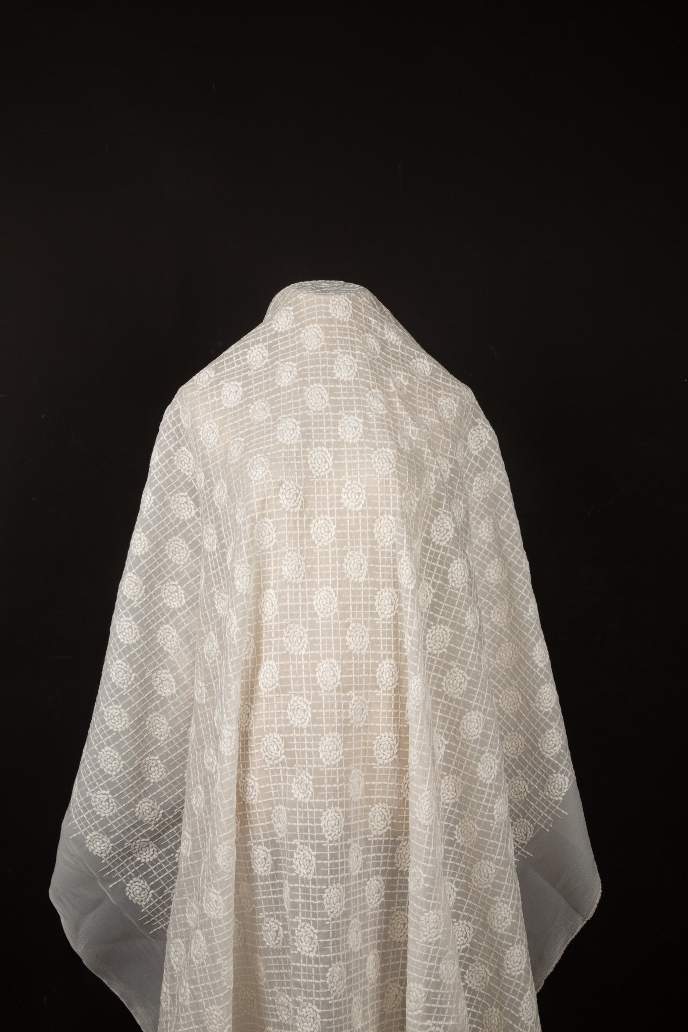 An ivory-white flat embroidery organza fabric, with a pattern combining a grid and floral-filled polka dots.
