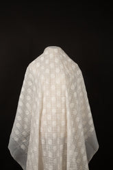 An ivory-white flat embroidery organza fabric, with a pattern combining a grid and floral-filled polka dots.