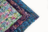 A 3D textured, plaid-patterned embroidery fabric with a plush feel, in a soft pastel palette.
   A 3D textured, plaid-patterned embroidery fabric with a plush feel, in a rich palette of purple, burgundy, and orange.
   A 3D textured, plaid-patterned embroidery fabric with a plush feel, in a palette of various blues and teals.