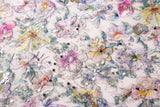 A dense, painterly floral sequin and thread embroidery fabric in a cool palette of purples and blues.