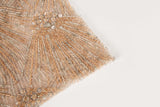 An Art Deco style beaded fabric, with a radiating palm leaf or sunburst pattern in a rose gold and silver palette.