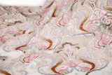 A luxurious sequin embroidery fabric, with a classic damask or brocade pattern in a soft, multi-color pastel palette.