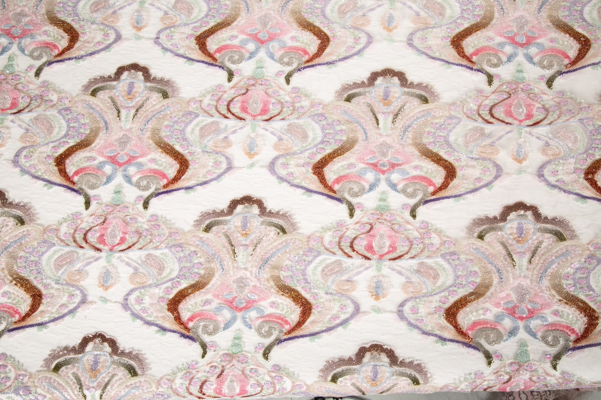 A luxurious sequin embroidery fabric, with a classic damask or brocade pattern in a soft, multi-color pastel palette.