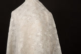 A lightweight, ivory-white flat embroidery organza fabric, with a variety of stylized, outline-floral motifs.