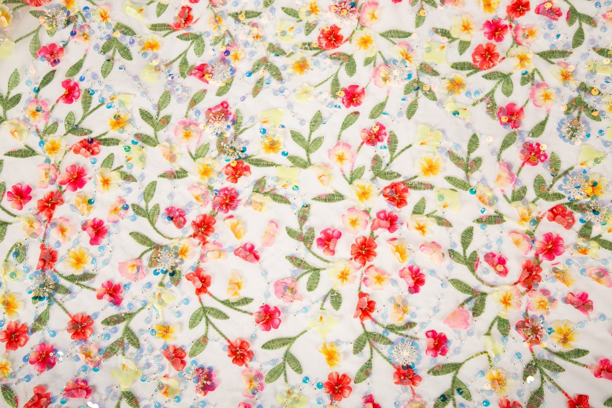 A 3D embroidery fabric with a multi-color wildflower pattern, embellished with sequins and beads.