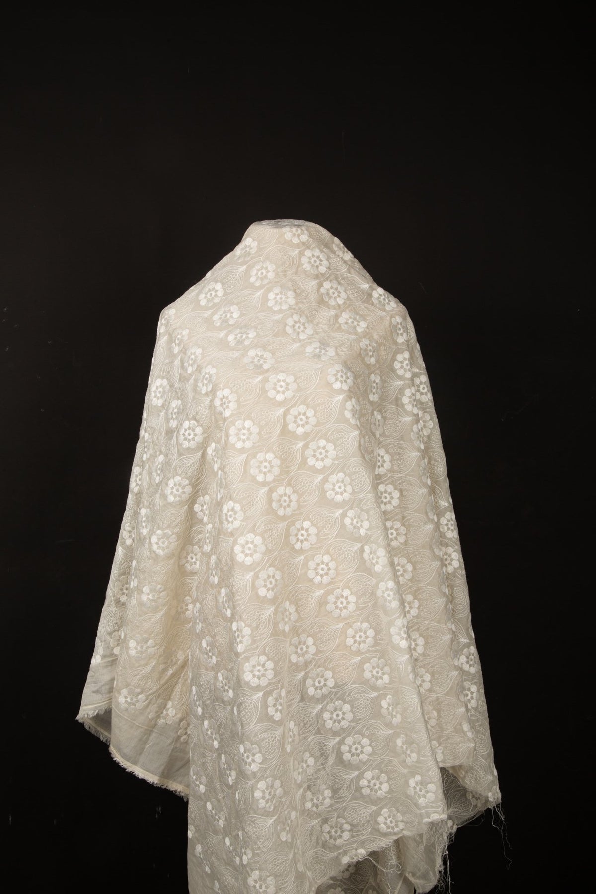An ivory-white flat embroidery organza fabric, with a repeating, damask-style floral pattern.
