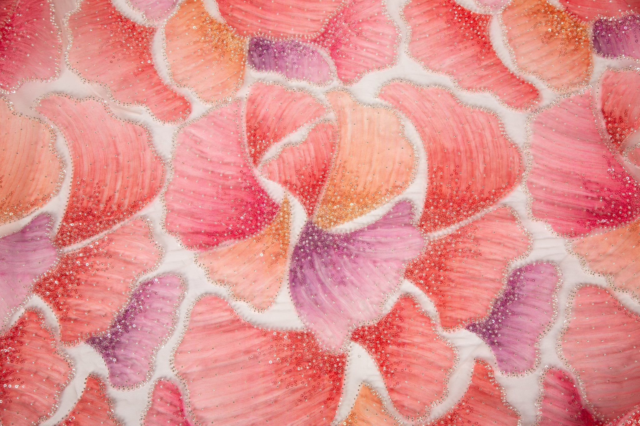 A 3D ribbon and bead embroidery fabric, with feathered petal motifs in a coral and purple gradient.
