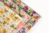     A 3D textured embroidery fabric with a plush feel, in a palette of yellow and green.
   A 3D textured embroidery fabric with a plush feel, in a palette of peach, pink, and green.
   A 3D textured embroidery fabric with a plush feel, in a palette of purple, pink, and green.
