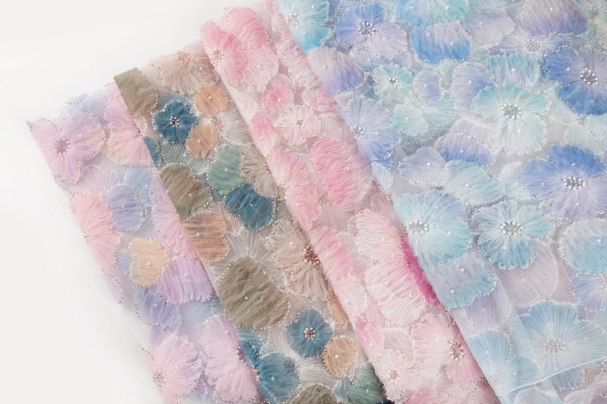    Ice blue, lavender, and white crinkle ribbon embroidered floral fabric.
   Peach, cream, and light pink crinkle ribbon embroidered floral fabric.
    Lavender, pale blue, and soft yellow crinkle ribbon embroidered floral fabric.
   Pink, yellow, and peach crinkle ribbon embroidered floral fabric.
