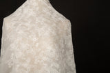 An ivory-white flat embroidery organza fabric, with an abstract, continuous-line floral pattern resembling line art.
