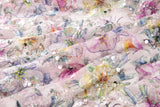 A dense, painterly floral sequin and thread embroidery fabric in a cool palette of purples and blues.
