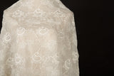 An ivory-white flat embroidery cotton fabric, with a repeating, classic paisley pattern.
