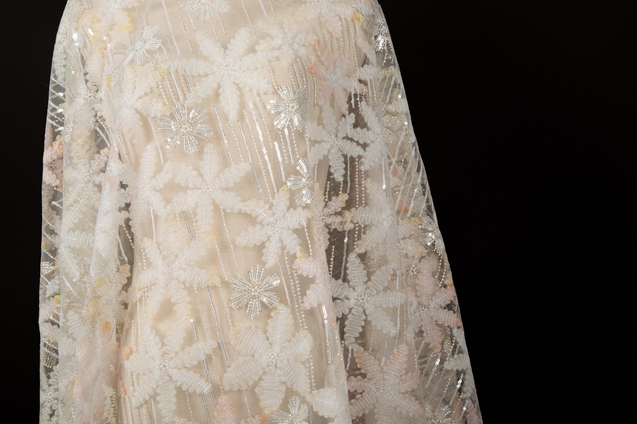 Orange 3D textured floral and silver sequin embroidery fabric.