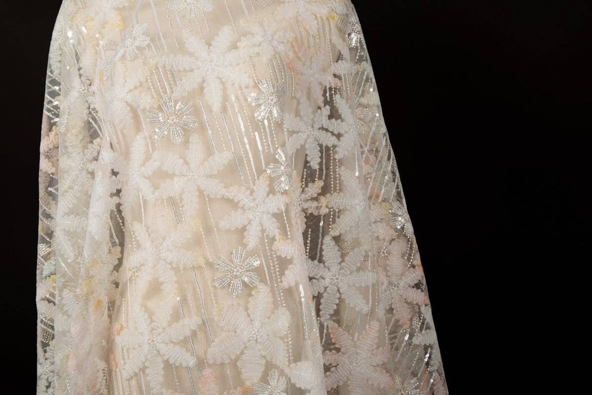 Orange 3D textured floral and silver sequin embroidery fabric.