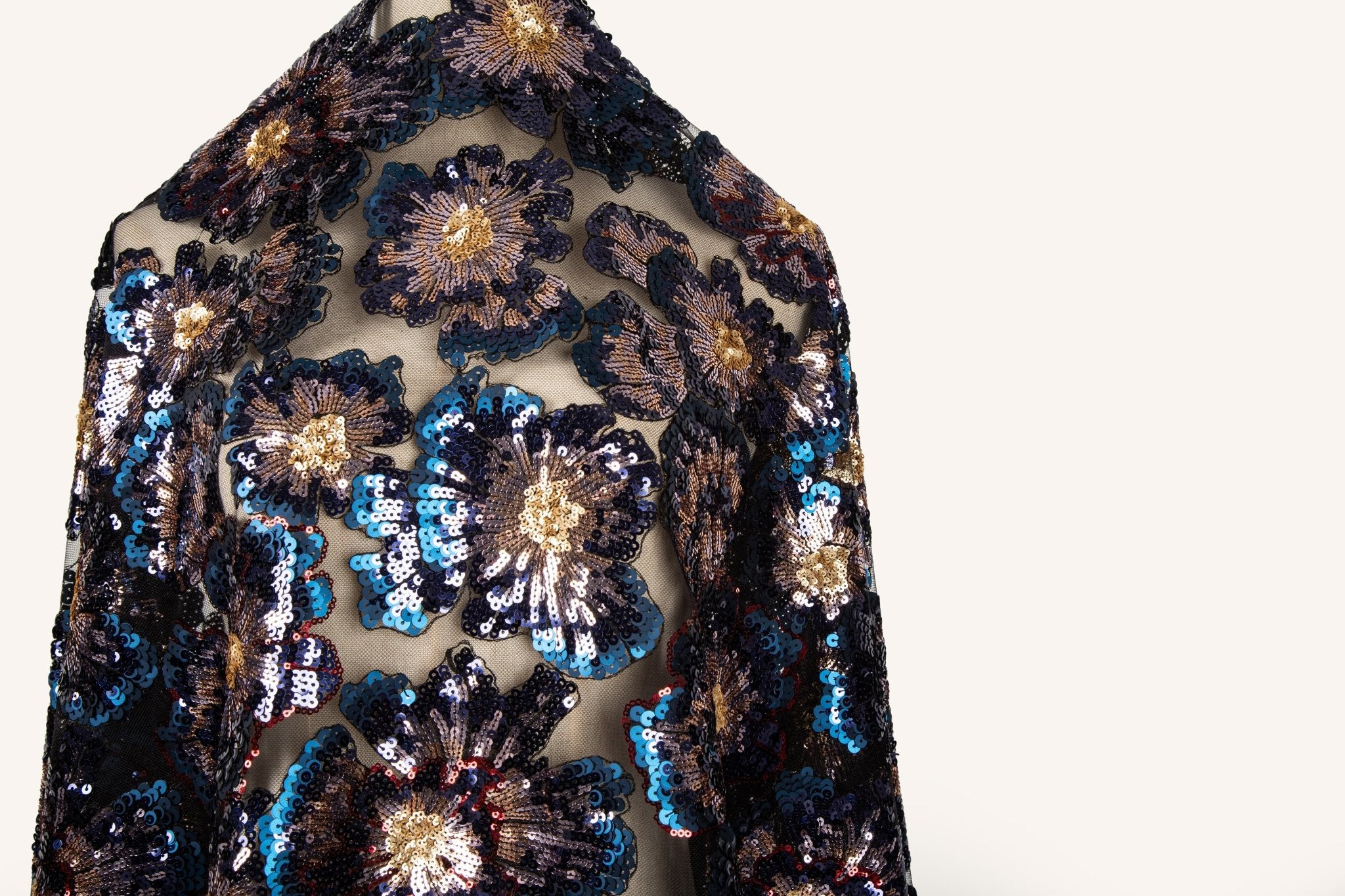  A large floral sequin embroidery fabric on a black base, with blue and gold motifs.
