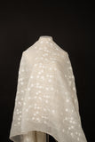 An ivory-white crinkle cotton embroidery fabric, with a horizontal wavy pattern of polka dots and thorny vine lines.
