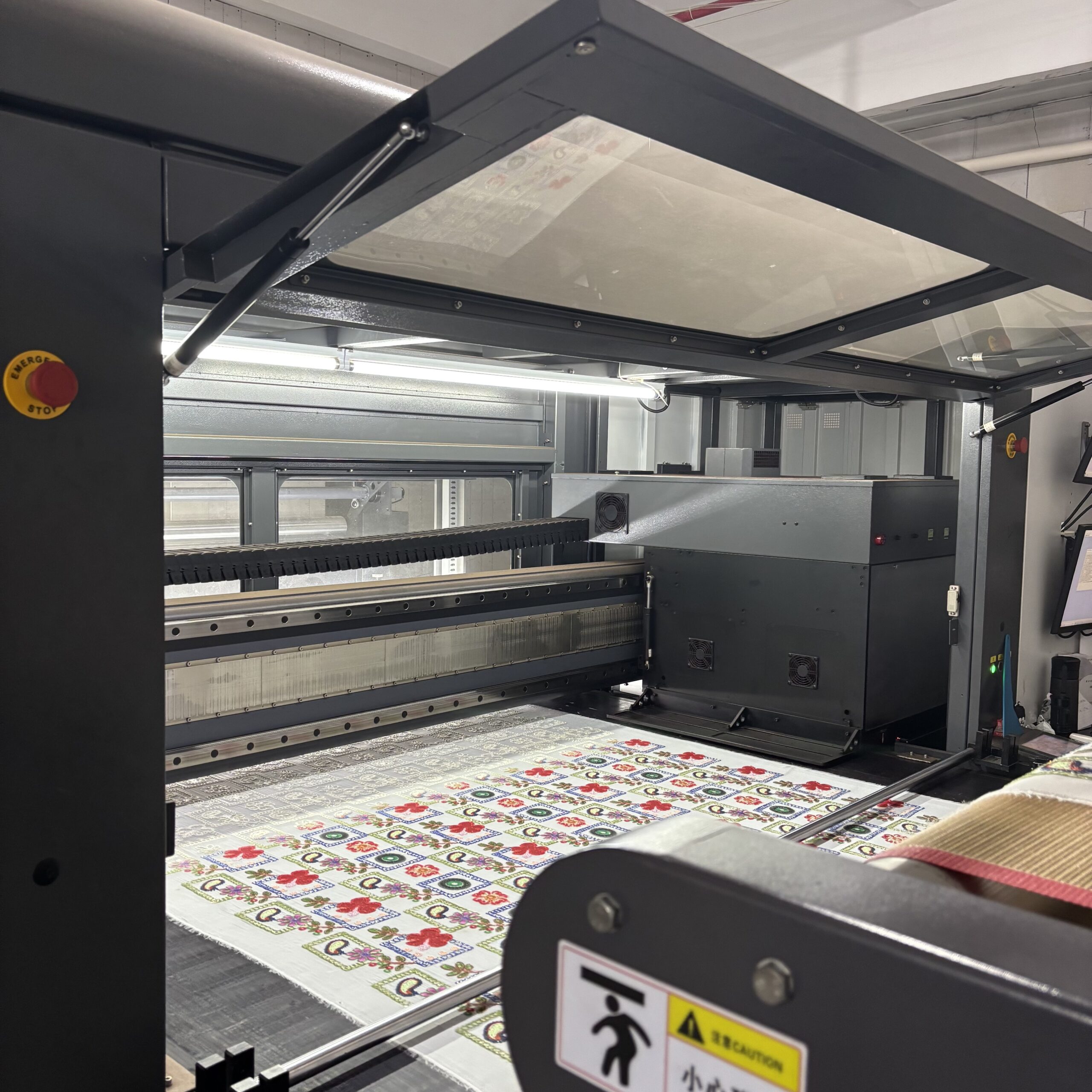 Digital Direct Printing Industrial vision system performing high-precision digital over-printing on embroidered apparel fabric.