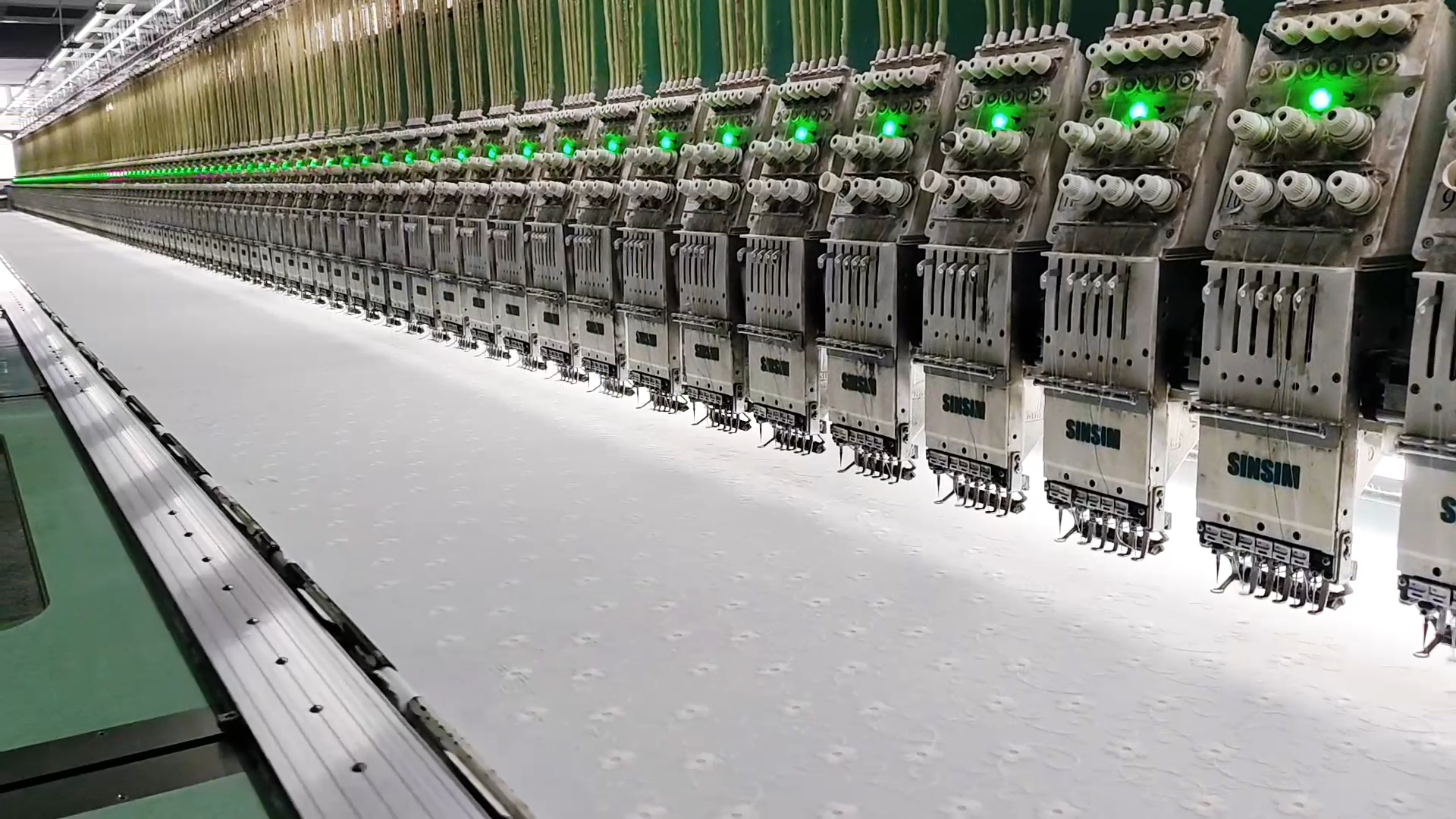 Advanced multi-head embroidery machines processing premium custom apparel fabrics