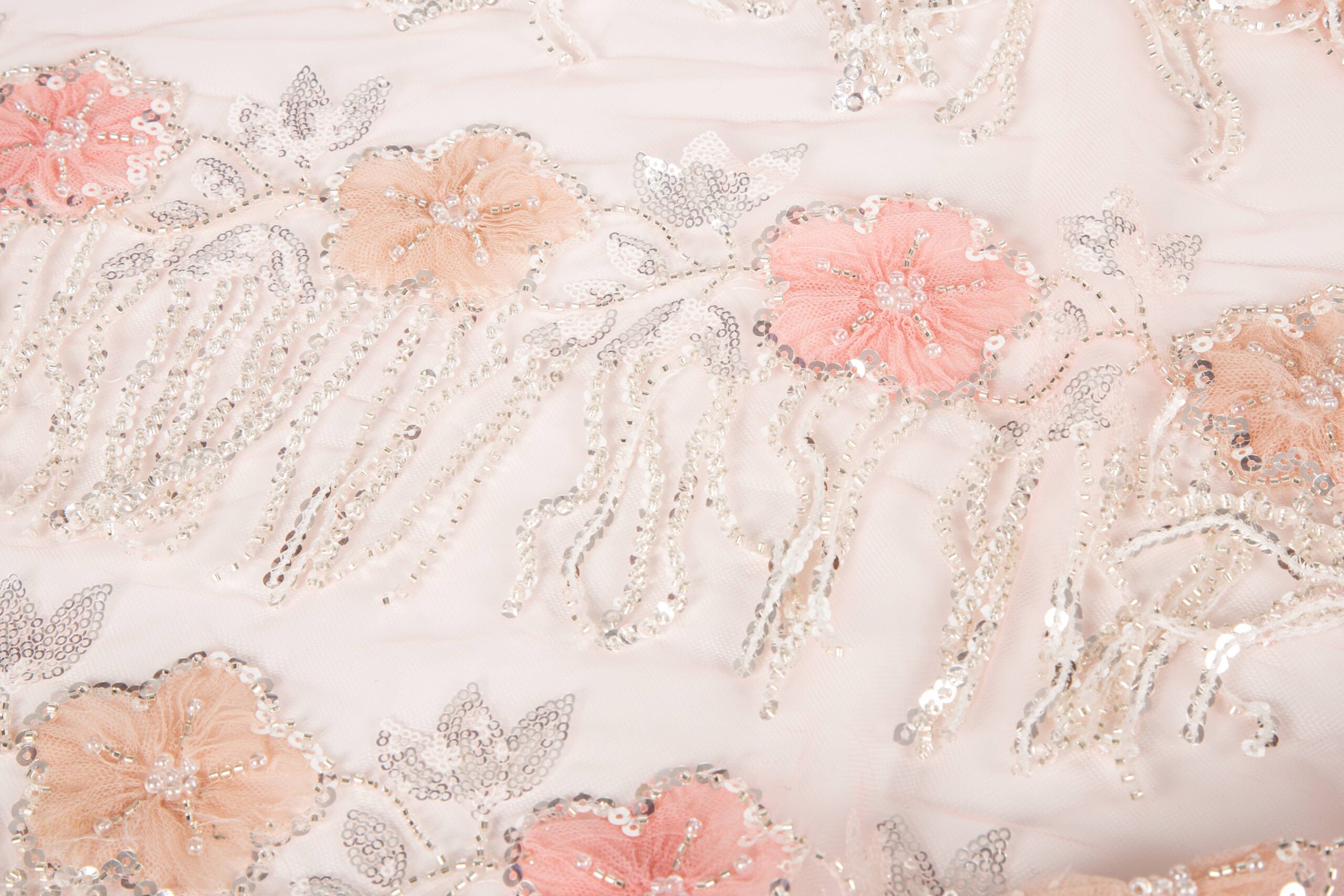 Detailed shot of 3D rope embroidery combined with heavy layers of sequins and beads, showing a rich and textured fabric style