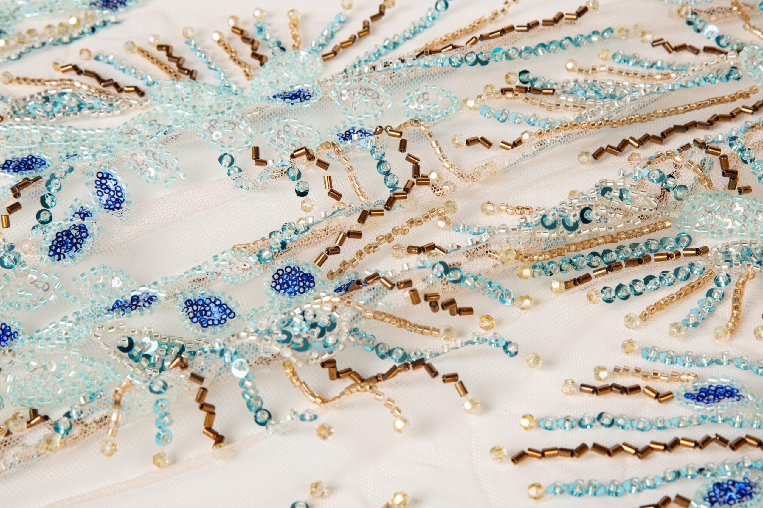 Premium Machine Beaded Embroidery Fabric Collection A high-resolution close-up of premium textiles strictly embroidered with beads, showcasing high-density beaded embroidery and secure embroidery and beads on fabric for industrial garment manufacturing.