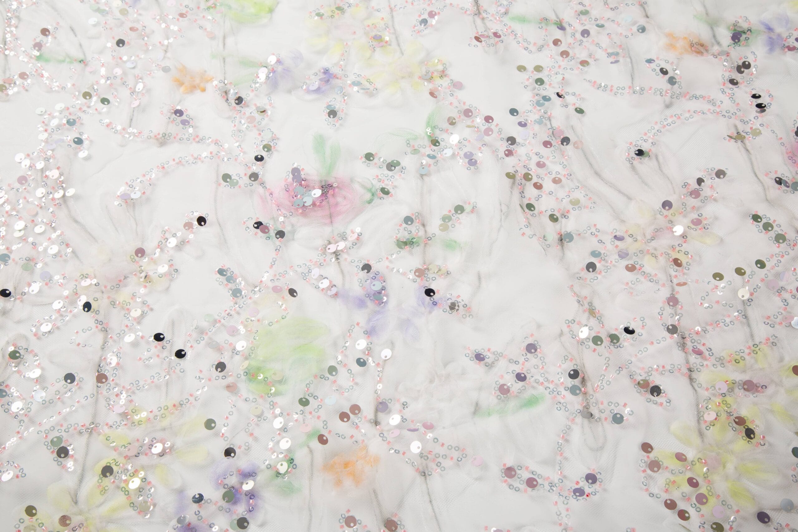 3D Tape & Sequin Embroidery Decorative sequins introduce reflective highlights that complement the dimensional floral elements.