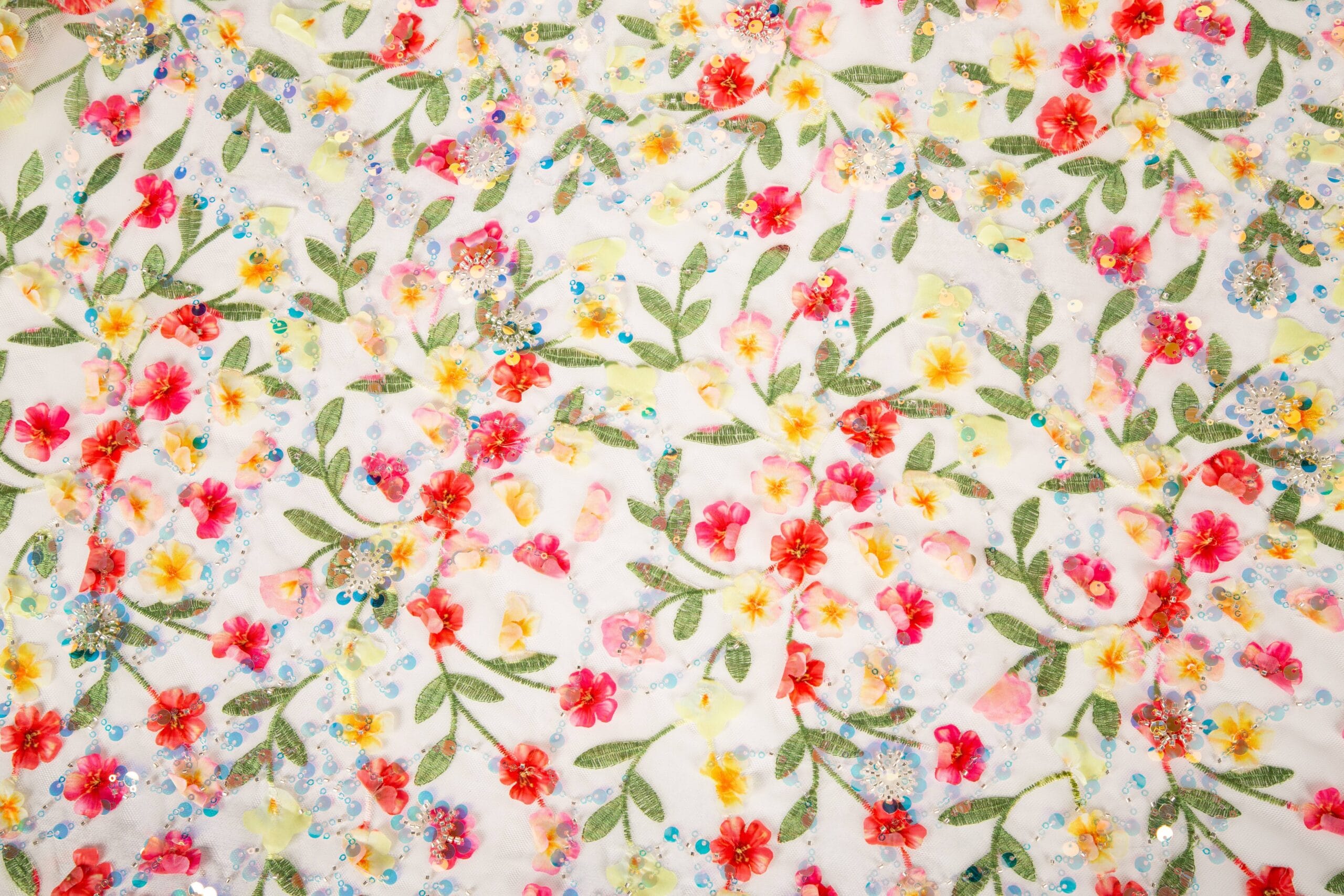 Applique Embroidery Fabric Detail on Tulle Mesh Close-up of applique embroidery fabric on tulle mesh showing layered floral motifs and decorative stitched edges